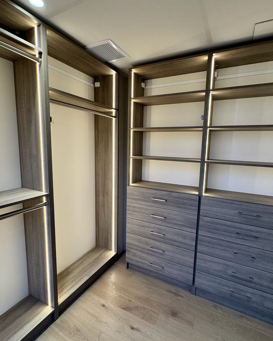 Primary Walk-In closet in oak with integrated LED lighting