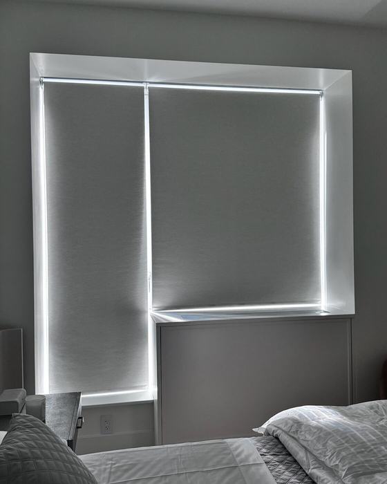 Primary suite bedroom with motorized blackout shades